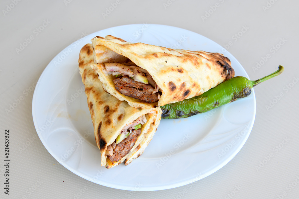 Lavash doner kebab ( zurna tavuk et doner durum )  or shawarma sliced in plate isolated. 