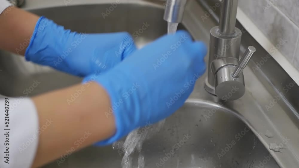 the hands of a dental assistant sterilize the dentist's working tool by washing it under the pressure of clean water from the tap and lathering it thoroughly with foam of a special agent. Disinfection the hands of a dental assistant sterilize the dentist's working tool by washing it under the pressure of clean water from the tap and lathering it thoroughly with foam of a special agent. Disinfection