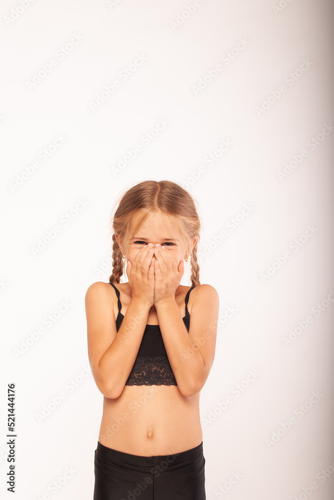 blonde girl looks overthinked at the camera holding her hands to her face on a white background in isolation.