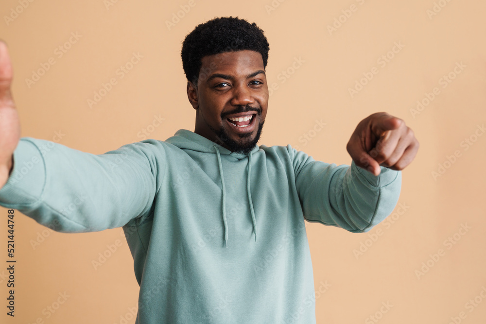 Black bearded young man smiling and taking selfie photo Black bearded young man smiling and taking selfie photo