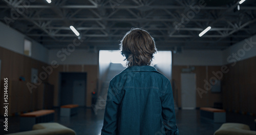 Wallpaper Mural Unknown teen schoolboy walking empty hallway. Student passing classrooms. Torontodigital.ca