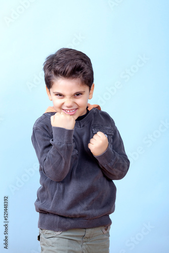 Little Boy is Threatning His Opponent on Blue photo