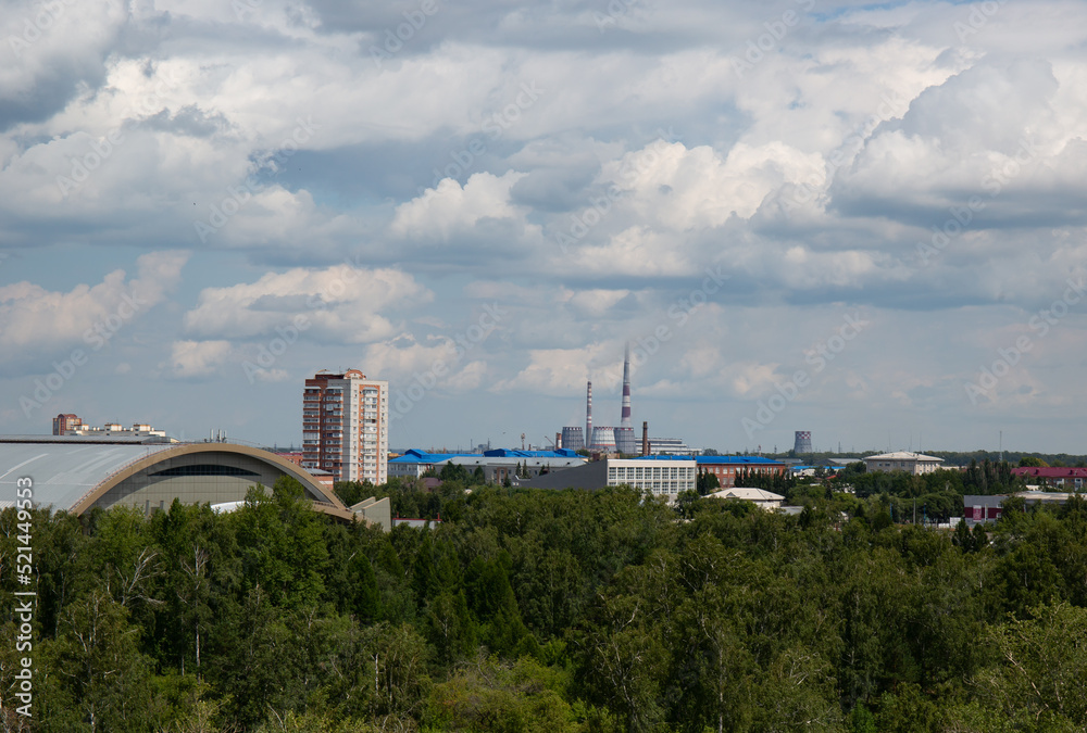Obraz premium View of the buildings from the Ferris wheel in the park named after the 30th anniversary of the Komsomol of Omsk in summer