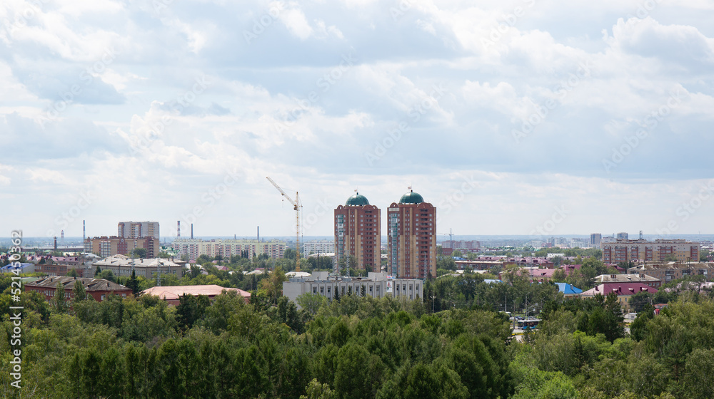 View of the buildings from the Ferris wheel in the park named after the 30th anniversary of the Komsomol of Omsk in summer