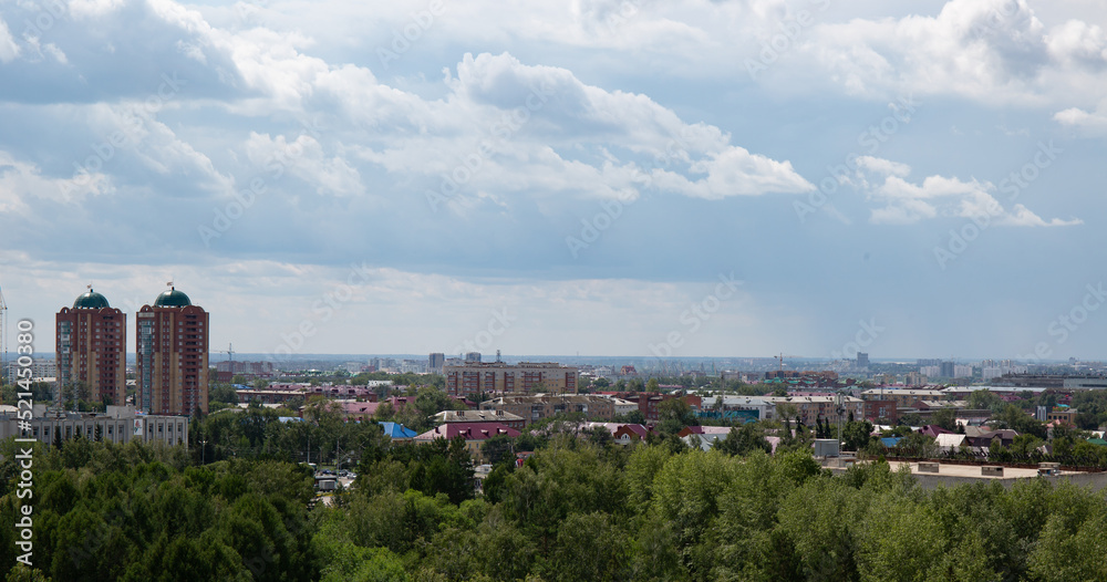 Fototapeta premium View of the buildings from the Ferris wheel in the park named after the 30th anniversary of the Komsomol of Omsk in summer