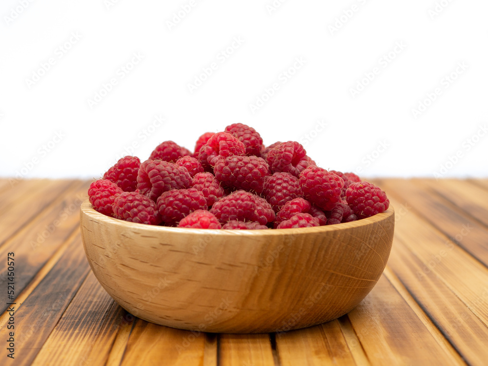 Raspberries in wooden bowl. Raspberry with copy space for text. Raspberries in wooden bowl. Raspberry with copy space for text.