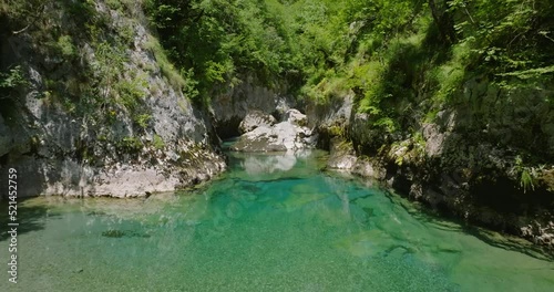 flying over a crystal clear blue water of mrtvica river in canyon photo