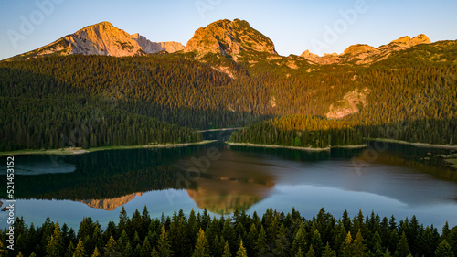 aerial view on durmitor mountain range and black lake with reflections in water