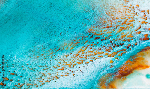 Artistic texture painted with liquid acrylic paints. Fluid art for background, wallpapper or poster. Backdrop similar to the landscape of the ocean. Sea artwork with turquoise waves and white foam.