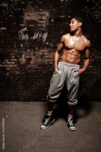 The Jock. Low key images of an athletic young man showing off his physique. Part of a series of images of the same model.