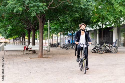 Wallpaper Mural stylish young man riding his bike through the city Torontodigital.ca