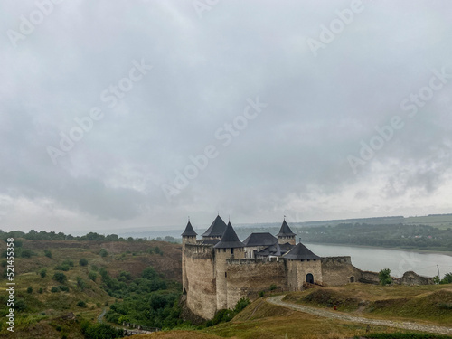 Aerial view of old castle near the River. Hotyn Castle in Ukraine. Eastern Europe.