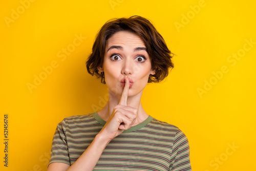 Closeup photo of young lady keeping secret poked work stay silent isolated on bright yellow color background photo
