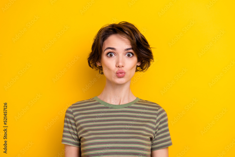 Portrait of young funny lady pouted lips make photo look directly you isolated on bright yellow color background Portrait of young funny lady pouted lips make photo look directly you isolated on bright yellow color background