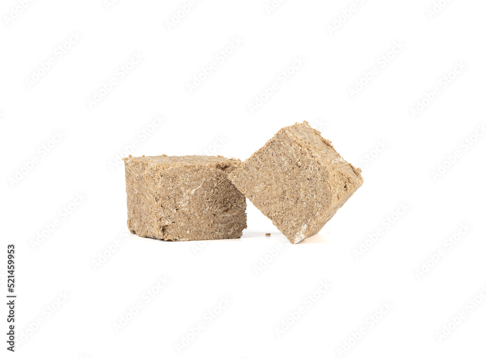 Two pieces of sweet sunflower halva on a white background. Two pieces of sweet sunflower halva on a white background.