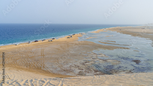 qatar adventurous place khor al udeid ,sea line beach during sunset. photo