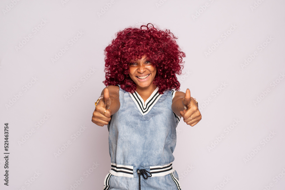 pretty young black lady does thumbs up gesture and smiling pretty young black lady does thumbs up gesture and smiling