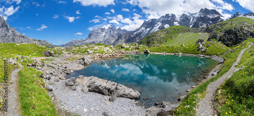 Fototapeta Naklejka Na Ścianę i Meble -  The panorma of Oberhornsee with the Jungfrau, Mittaghorn and Grosshorn peaks.