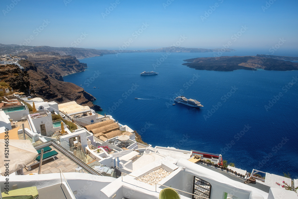 Fototapeta premium Beautiful white architecture of Santorini island, summer landscape with blue sky, sea and caldera view, outdoor travel background, Imerovigli, Greece