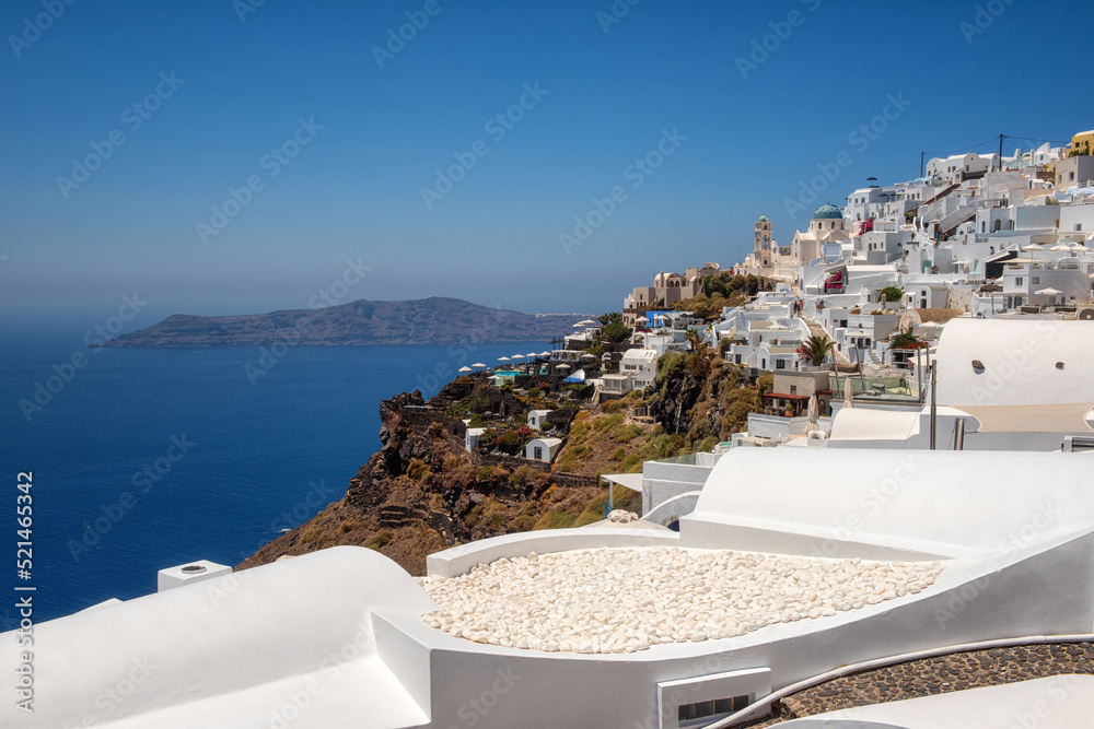 Fototapeta premium Beautiful white architecture of Santorini island, summer landscape with blue sky, sea and caldera view, outdoor travel background, Imerovigli, Greece