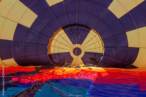 view from the inside of a balloon with straps, which is currently inflated with hot air and lies on the ground in preparation for flight