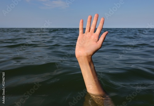 hand of the person who drowns in the sea photo
