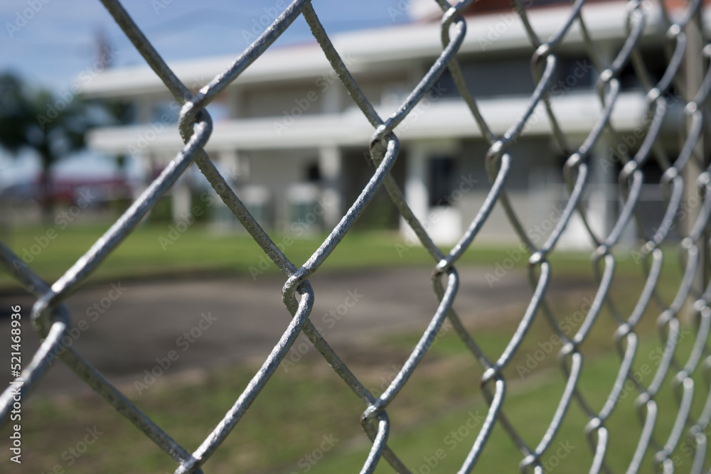 The fence is made of metal wire. The fence is made of metal wire.