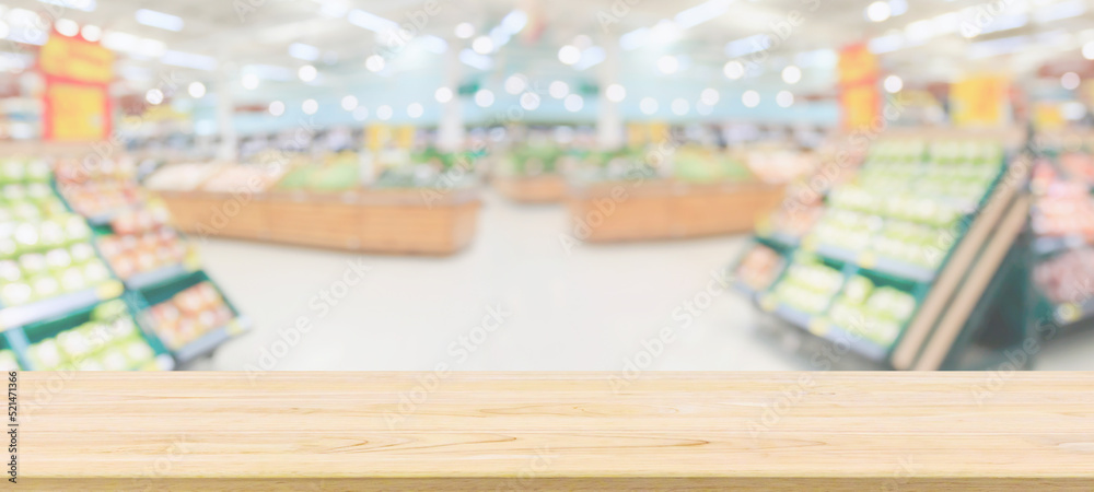 Wood table top with supermarket grocery store blurred defocused background with bokeh light for product display