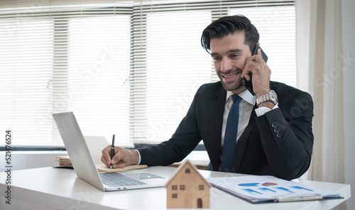 Real estate brokers talk on the phone to recommend investments to clients.