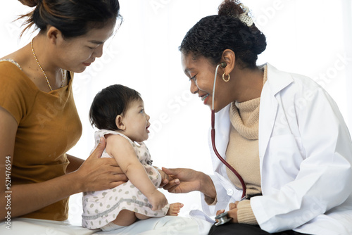 mother and baby visit to the doctor using stethoscope checking heart beat