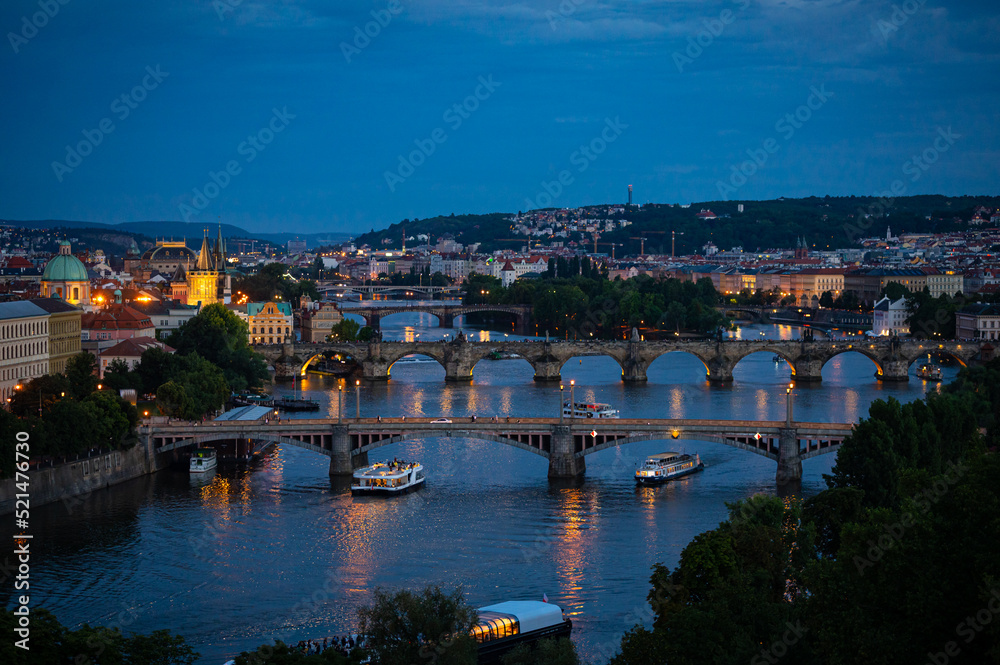 Famous bridges over river Vltava in the old town of Prague after sunset, during blue hour