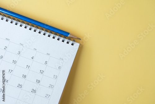 close up of calendar on the yellow table background, planning for business meeting or travel planning concept