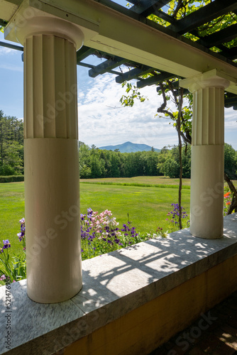 View of Mount Ascutney and  Connecticut River Valley. Purple iris, and Columbine flowers in the foreground. View from Little Studio at Saint-Gaudens National Historic Site. Colonnade and arbor. photo