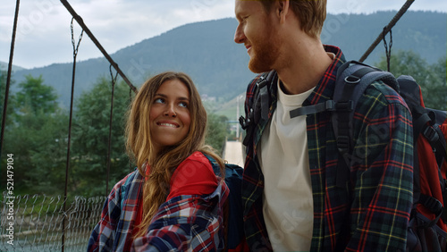 Happy couple dancing nature on mountain bridge. Lovers having fun on hitchhike. photo