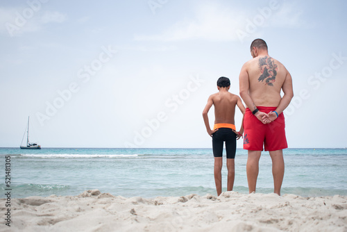 Uncle and nephew on a beach in Menorca on a summer day