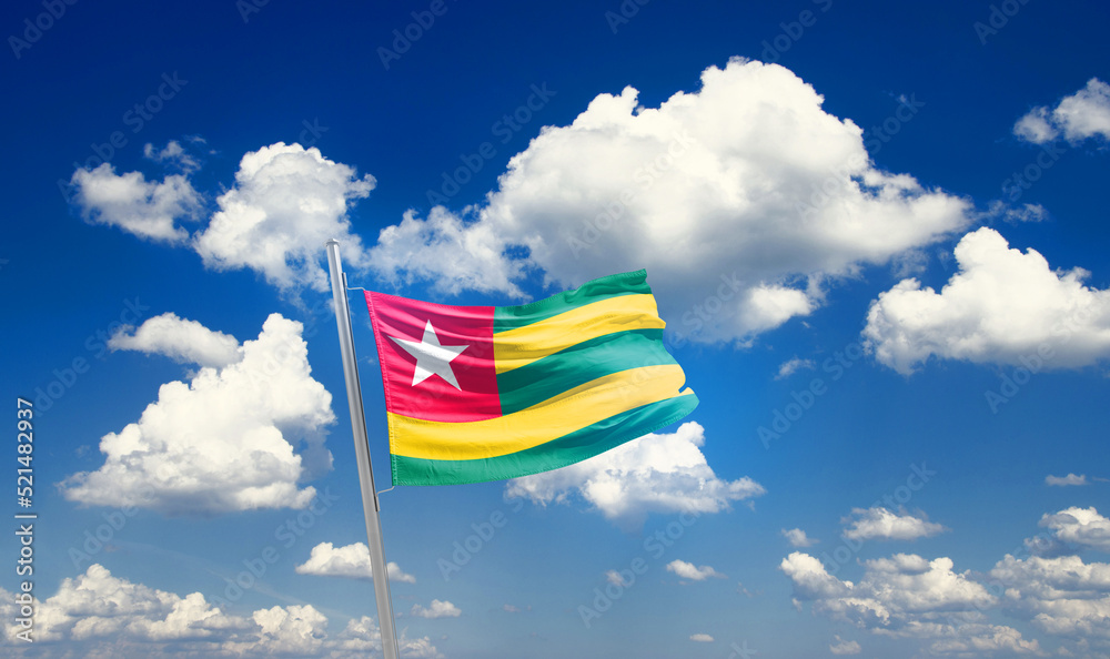 Togo national flag cloth fabric waving on the sky - Image