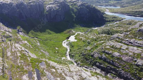 Mountains of Norway. Mountain lakes and rivers. Green trees in the mountains. Flying a drone in the mountains. Blue clear sky. Video 4k