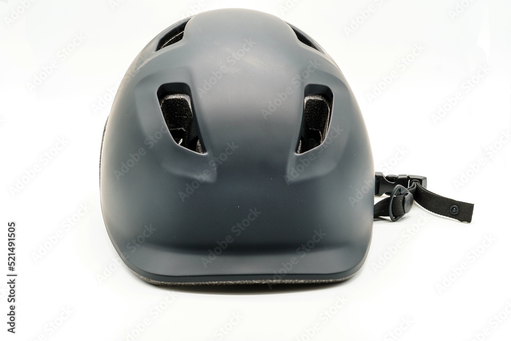 Black cycling helmet with ventilation holes on the head. Safety and