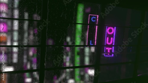 Rainy window with a neon Chill out sign against the backdrop of the city at night.