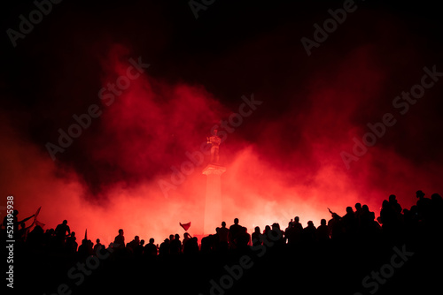 Red Star Football fans with torches and flags celebrating league title win next to monument Pobednik in Belgrade, Serbia 22.05.2022