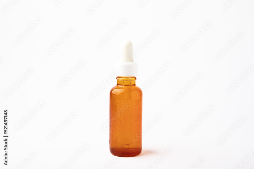 Essential oil in a glass bottle with a pipette. Bottle with fragrant oil isolated on white background. essential oil mockup with copy space. serum. Essential oil in a glass bottle with a pipette. Bottle with fragrant oil isolated on white background. essential oil mockup with copy space. serum.