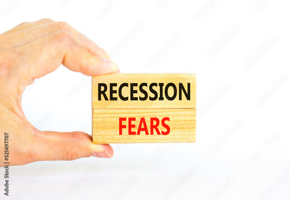 Recession fears symbol. Concept words Recession fears on wooden blocks on a beautiful white table white background. Businessman hand. Business and recession fears concept. Copy space. Recession fears symbol. Concept words Recession fears on wooden blocks on a beautiful white table white background. Businessman hand. Business and recession fears concept. Copy space.