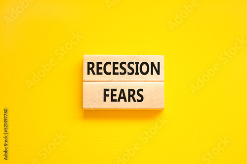 Recession fears symbol. Concept words Recession fears on wooden blocks on a beautiful yellow table yellow background. Business and recession fears concept. Copy space.