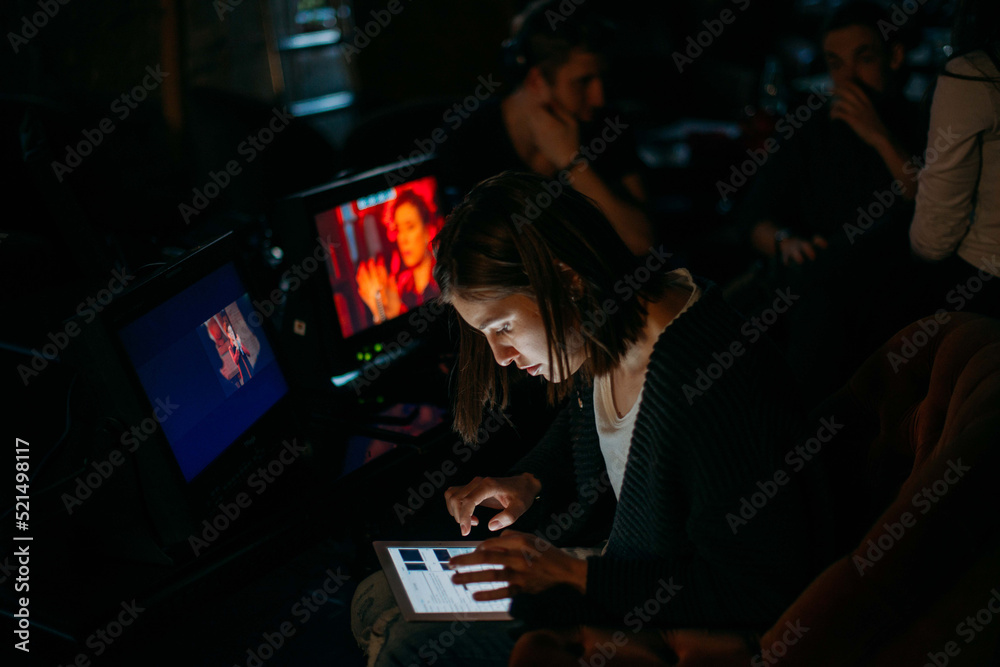 Director at work on the set. The director works with a group or with a playback while filming a movie, advertising, or a TV series. Shooting shift, equipment and group.