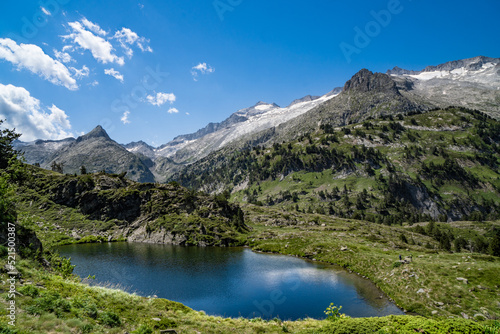 Spectacular  wonderful and evocative landscape of a lake in the Pyrenees surrounded by mountains and snow-capped peaks of Benasque. In HDR color.