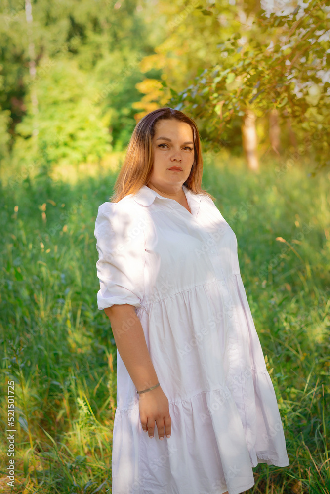 A beautiful girl walks in the forest with daisies at sunset of the day. A beautiful girl walks in the forest with daisies at sunset of the day.