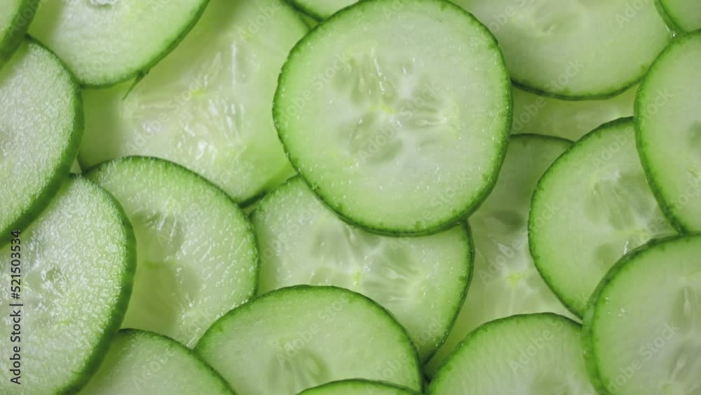 closeup of freshly cut cucumber slices rotating closeup of freshly cut cucumber slices rotating