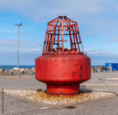 21 July 2022. Macduff, Aberdeenshire, Scotland. This is a Red Marker Buoy, ashore at Macduff Harbour. photo