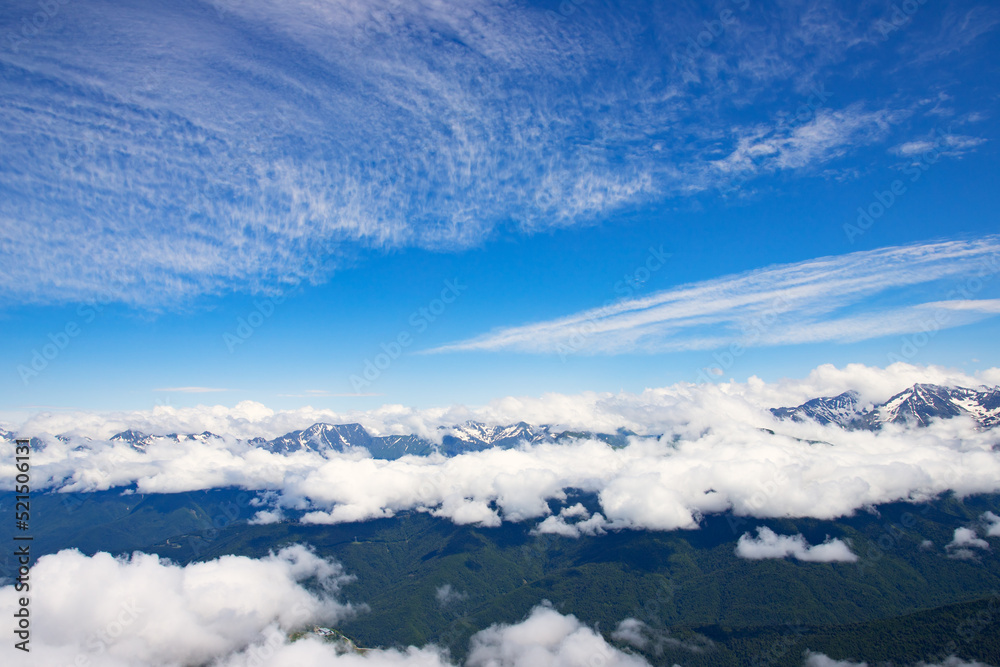 mountain landscape with blue sky above clouds, hilltops and natural green forests, trekking and hiking mountain landscape with blue sky above clouds, hilltops and natural green forests, trekking and hiking