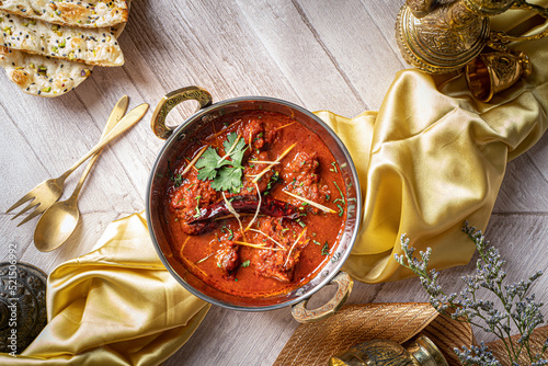 Indian spices Jodhpuri Laal Gosht or beef karahi with roti and kulcha served in a dish isolated on dark background top view of fastfood